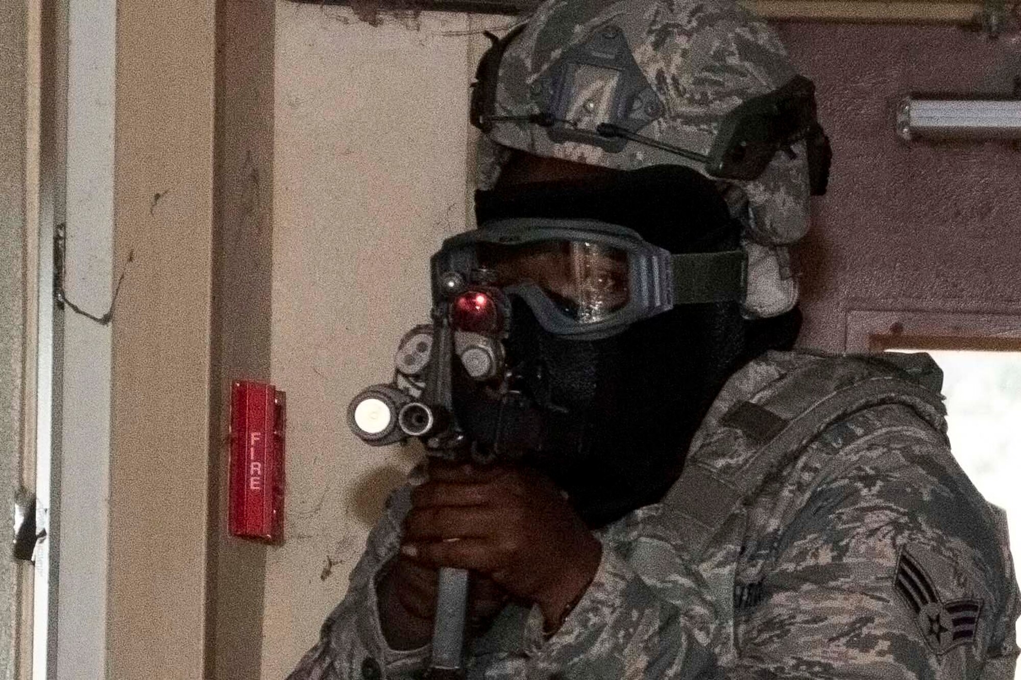 Photo of Airman pointing rifle.