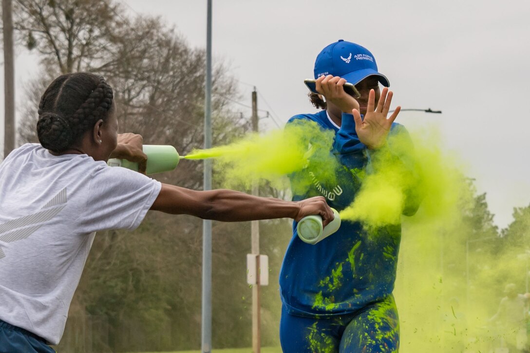 Photo of runner being hit with colored dye during a 5K race.