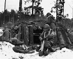 U.S. Army Soldiers of the 42nd Infantry Division prepare a defensive position at their log and dirt bunker near Kauffenheim, France, Jan. 8, 1945. The Soldiers, assigned to Company I, 242nd Regiment, held off the German offensive in Alsace, France, called Operation Nordwind without the division’s artillery or support elements. The actions of one division Soldier, Master Sgt. Vito Bertoldo, were highlighted in the 2018 Netflix documentary “Medal of Honor.”