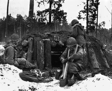 U.S. Army Soldiers of the 42nd Infantry Division prepare a defensive position at their log and dirt bunker near Kauffenheim, France, Jan. 8, 1945. The Soldiers, assigned to Company I, 242nd Regiment, held off the German offensive in Alsace, France, called Operation Nordwind without the division’s artillery or support elements. The actions of one division Soldier, Master Sgt. Vito Bertoldo, were highlighted in the 2018 Netflix documentary “Medal of Honor.”
