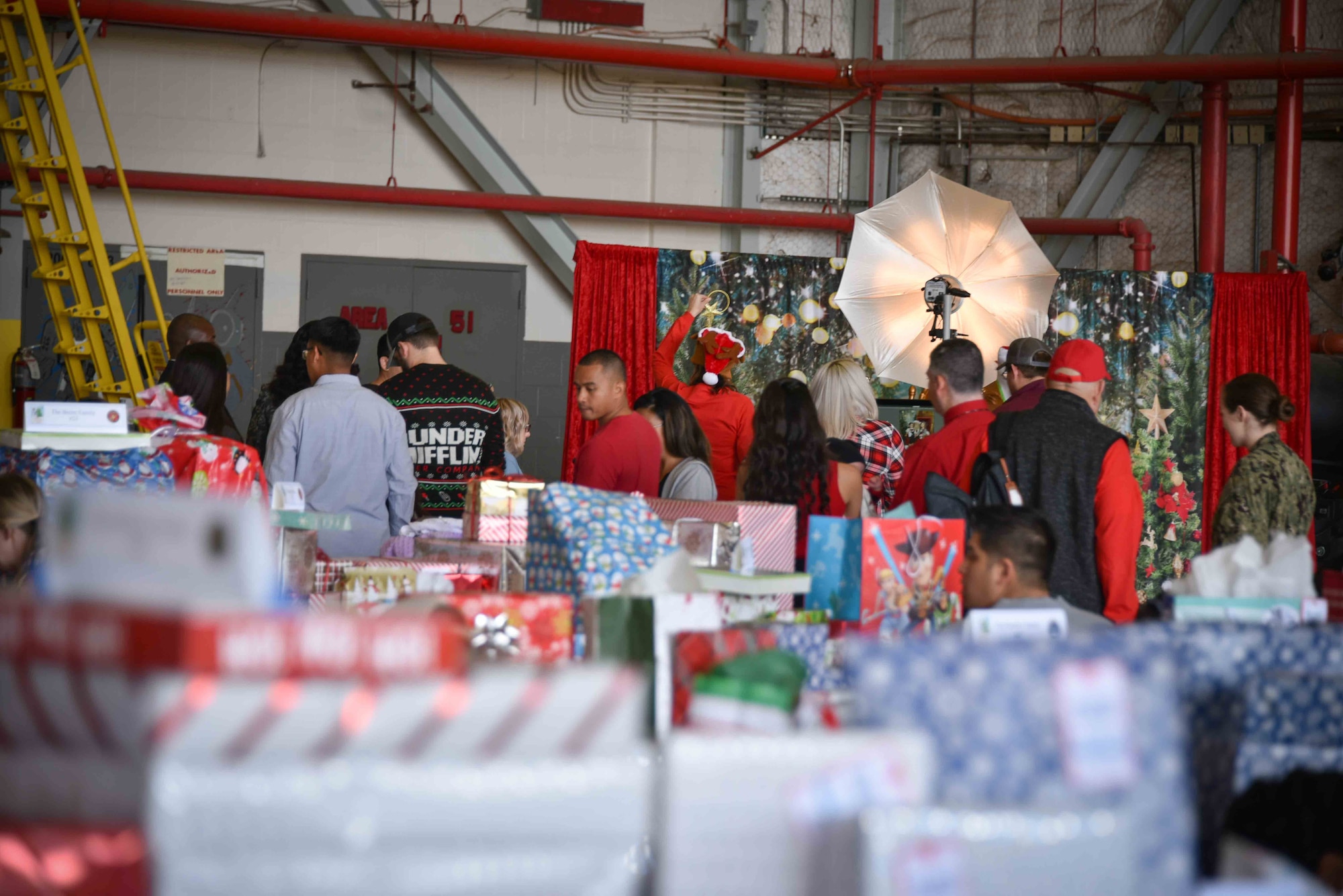 Several of the 75 military families (150 children and 130 adults) enjoy the opportunity to take photos and spend family time together at the 5th Annual Holidays & Heroes event held for the first time on base at the VR-59 hangar, NAS Fort Worth JRB, Texas on Dec. 5, 2019. From gifts to family photos and bounce houses to arts and crafts, 'the force' was definitely felt as all involved wanted to show support to these families for the holiday season. (U.S. Air Force photo by Mr. Jeremy Roman)