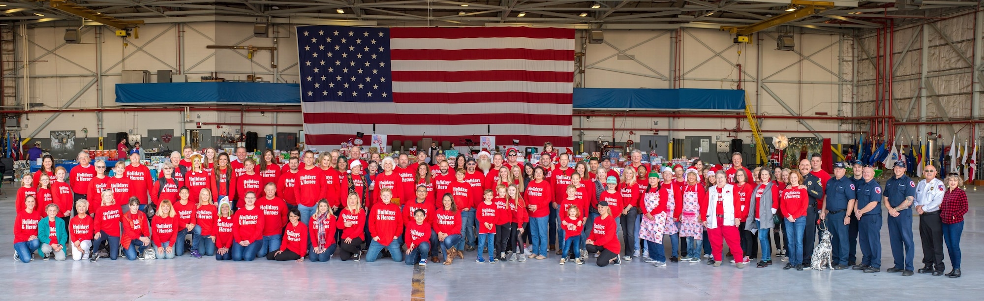 Approximately 150 volunteers came together to support the 5th Annual Holidays & Heroes event held for the first time on base at the VR-59 hangar, NAS Fort Worth JRB, Texas on Dec. 5, 2019. This holiday event, which was originated by 301 FW Security Forces Squadron Honorary Commander Mrs. Kerre Randel Ortegel and her husband Bob Ortegel, brought the military, Lockheed Martin and approximately 150 volunteers together to serve 75 military families (150 children and 130 adults) in need for holidays. (Courtesy photo)