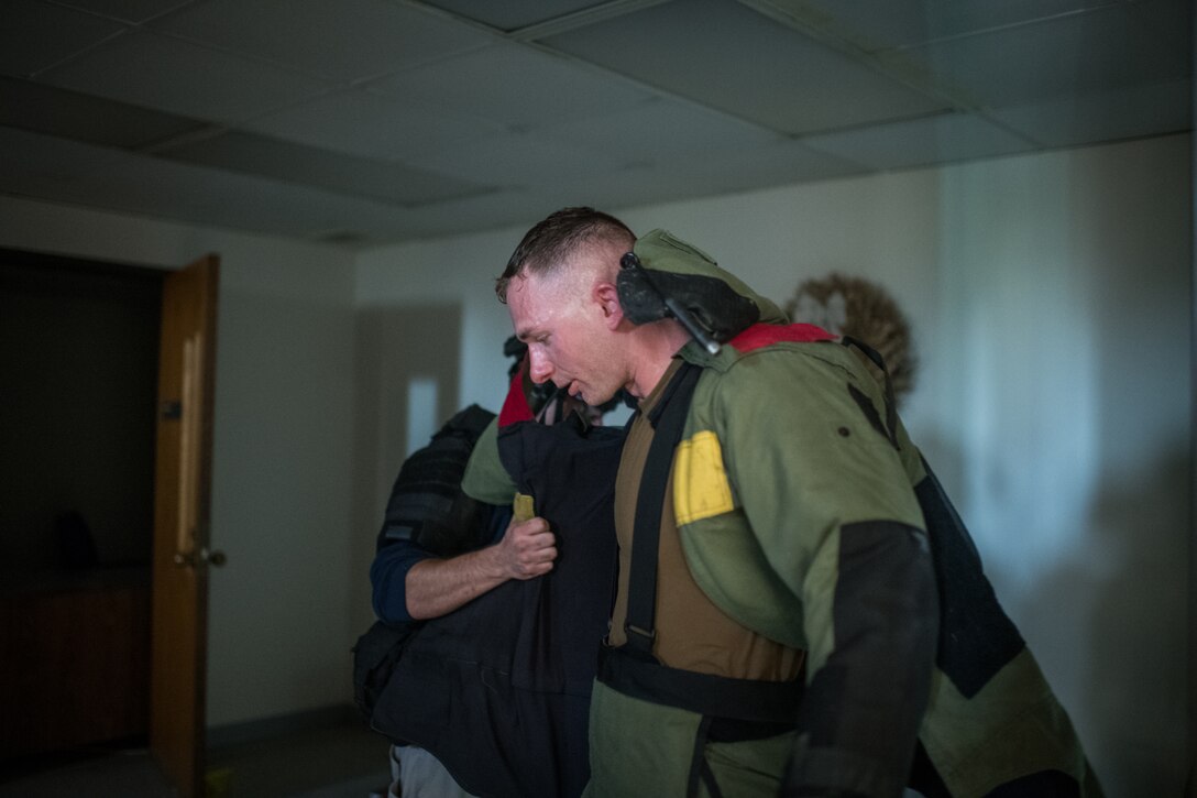 Staff Sgt. Bryan Meyer, 932nd Civil Engineer Squadron explosive ordnance disposal specialist, receives assistance with removing his protective explosive ordnance bomb-suit after conducting threat detection procedures during training in St. Louis, Oct. 22, 2019. Each team and had a chance to demonstrate their ability to respond to a simulated event. (U.S. Air Force photo by Christopher Parr)
