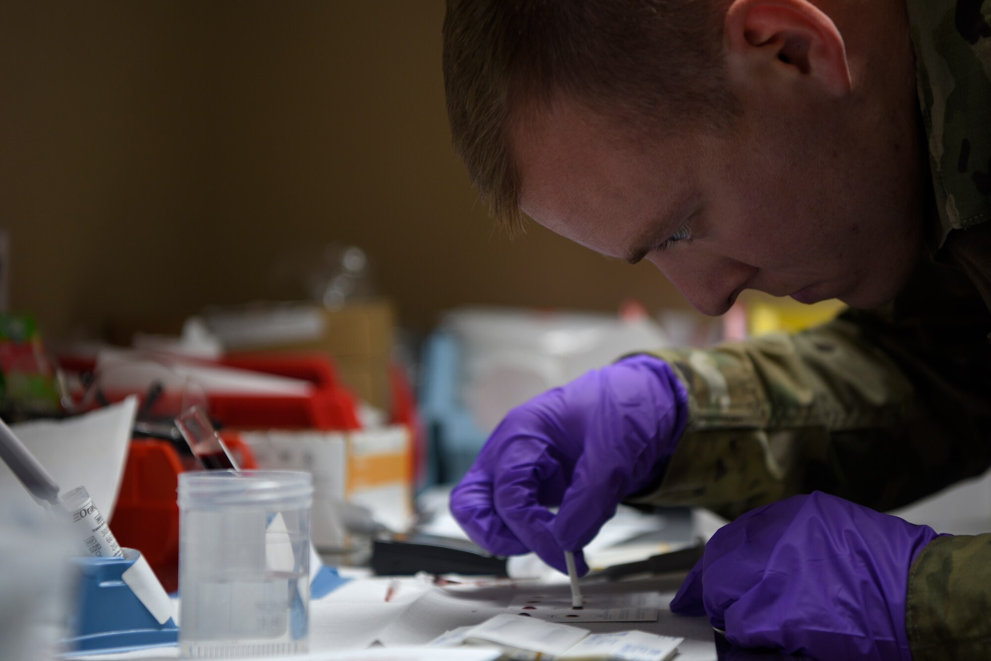 U.S. Air Force Staff Sgt. Duncan, 332d Expeditionary Medical Group medical technician, performs a blood typing test at the 332d Air Expeditionary Wing, Dec. 20, 2019. The 332 EMDG started the first walking blood bank for military members to provide blood in case of an emergency medical care incident. (U.S. Air Force photo by Tech. Sgt. Andrew Satran)