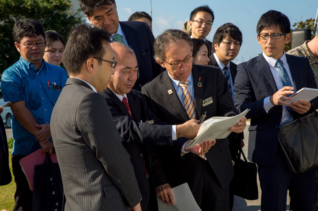 Okinawa Governor Denny Tamaki discusses with Mr. Norikazo Kinjo (pen in hand), director, Military Base Affairs Division, Okinawa Prefectural Government, plans for the Minatagawa Bypass Project and relocation of a gate for Camp Kinser, Okinawa, Japan, Jan. 31, 2019. The project is a bilateral agreement that return tracts of Camp Kinser in phases to enable the construction of a bypass road to relieve local traffic congestion. (U.S. Marine Corps photo by Lance Cpl. Nicole Rogge)
