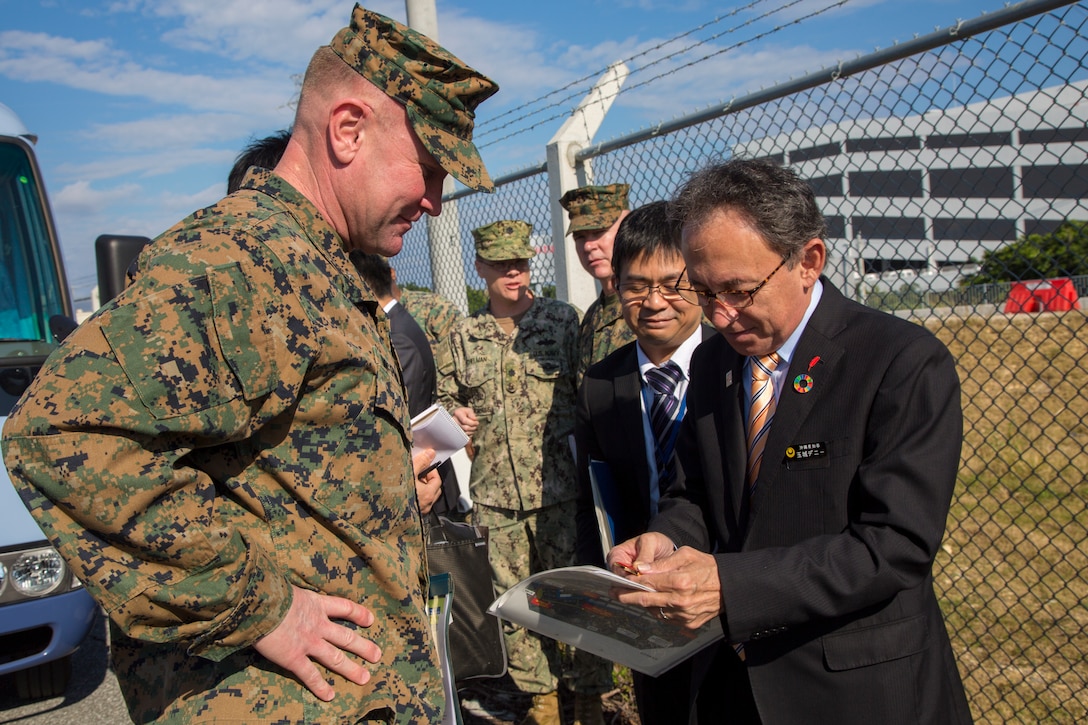 Mr. Shinya Ito, director, Planning Department, Okinawa Defense Bureau, discusses constructions plans with Okinawa Governor Denny Tamaki during a tour on Torii Station, Okinawa, Japan, Jan. 31, 2019. During the tour on Torii Station, members were shown plans to construct new buildings as part of the consolidation and relocation project. (U.S. Marine Corps photo by Lance Cpl. Nicole Rogge)