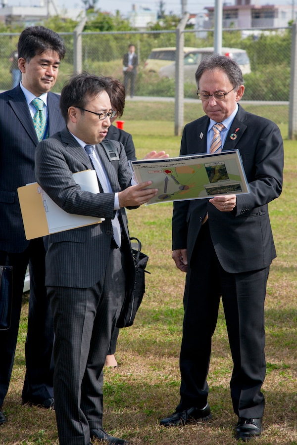 Mr. Shinya Ito, director, Planning Department, Okinawa Defense Bureau, discusses constructions plans with Okinawa Governor Denny Tamaki during a tour on Torii Station, Okinawa, Japan, Jan. 31, 2019. During the tour on Torii Station, members were shown plans to construct new buildings as part of the consolidation and relocation project. (U.S. Marine Corps photo by Lance Cpl. Nicole Rogge)