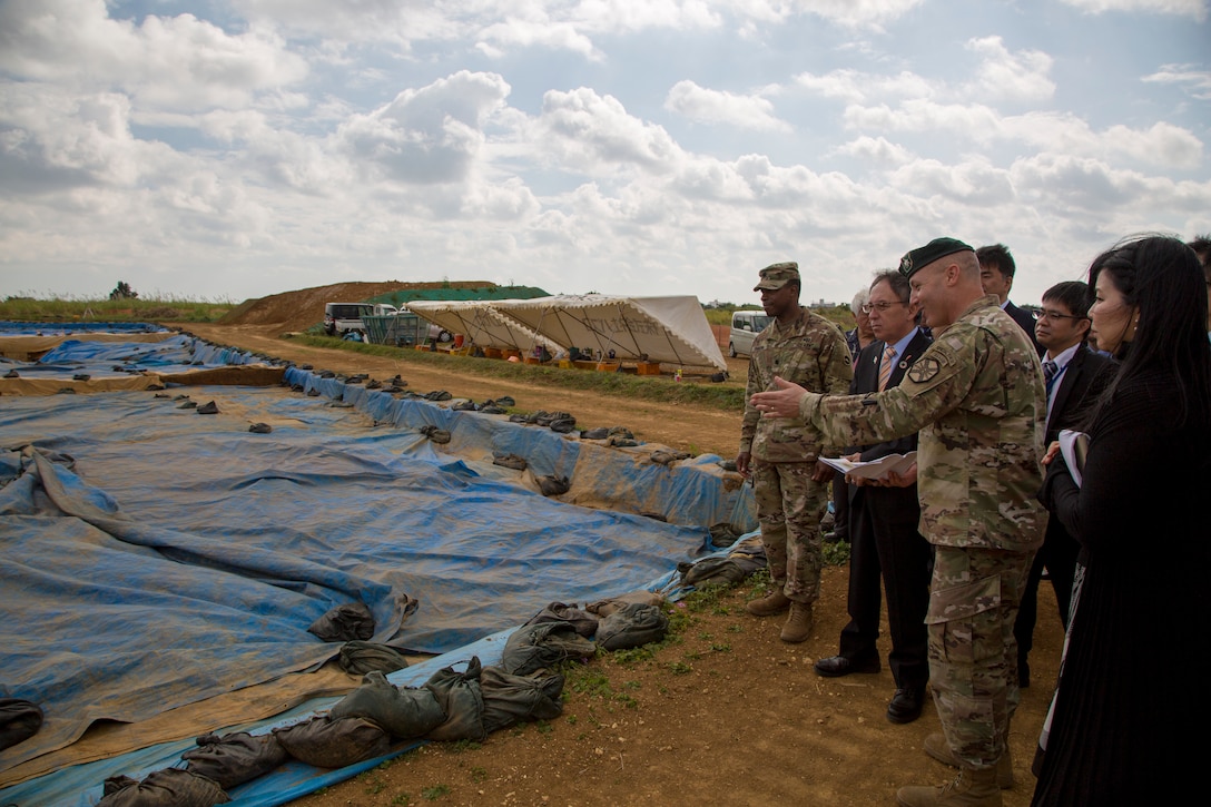 U. S. Army Garrison Okinawa Commander, Lt. Col. Zachary B. Hohn, shows Okinawa Governor, Denny Tamaki an excavation site during a tour on Torii Station, Okinawa, Japan, Jan. 31, 2019. Historical artifacts dating back 10,000 years were discovered at this location. During the tour on Torii Station, members were shown plans to construct new buildings as part of the consolidation and relocation project. (U.S. Marine Corps photo by Lance Cpl. Nicole Rogge)