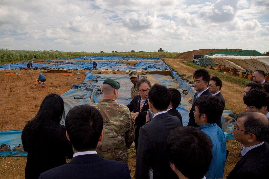 U. S. Army Garrison Okinawa Commander Lt. Col. Zachary B. Hohn shows Okinawa Governor Denny Tamaki an excavation site during a tour on Torii Station, Okinawa, Japan, Jan. 31, 2019. Historical artifacts dating back 10,000 years were discovered at this location. During the tour on Torii Station, members were shown plans to construct new buildings as part of the consolidation and relocation project. (U.S. Marine Corps photo by Lance Cpl. Nicole Rogge)