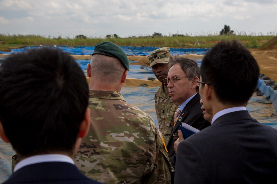 U. S. Army Garrison Okinawa Commander Lt. Col. Zachary B. Hohn shows Okinawa Governor Denny Tamaki an excavation site during a tour on Torii Station, Okinawa, Japan, Jan. 31, 2019. Historical artifacts dating back 10,000 years were discovered at this location. During the tour on Torii Station, members were shown plans to construct new buildings as part of the consolidation and relocation project. (U.S. Marine Corps photo by Lance Cpl. Nicole Rogge)