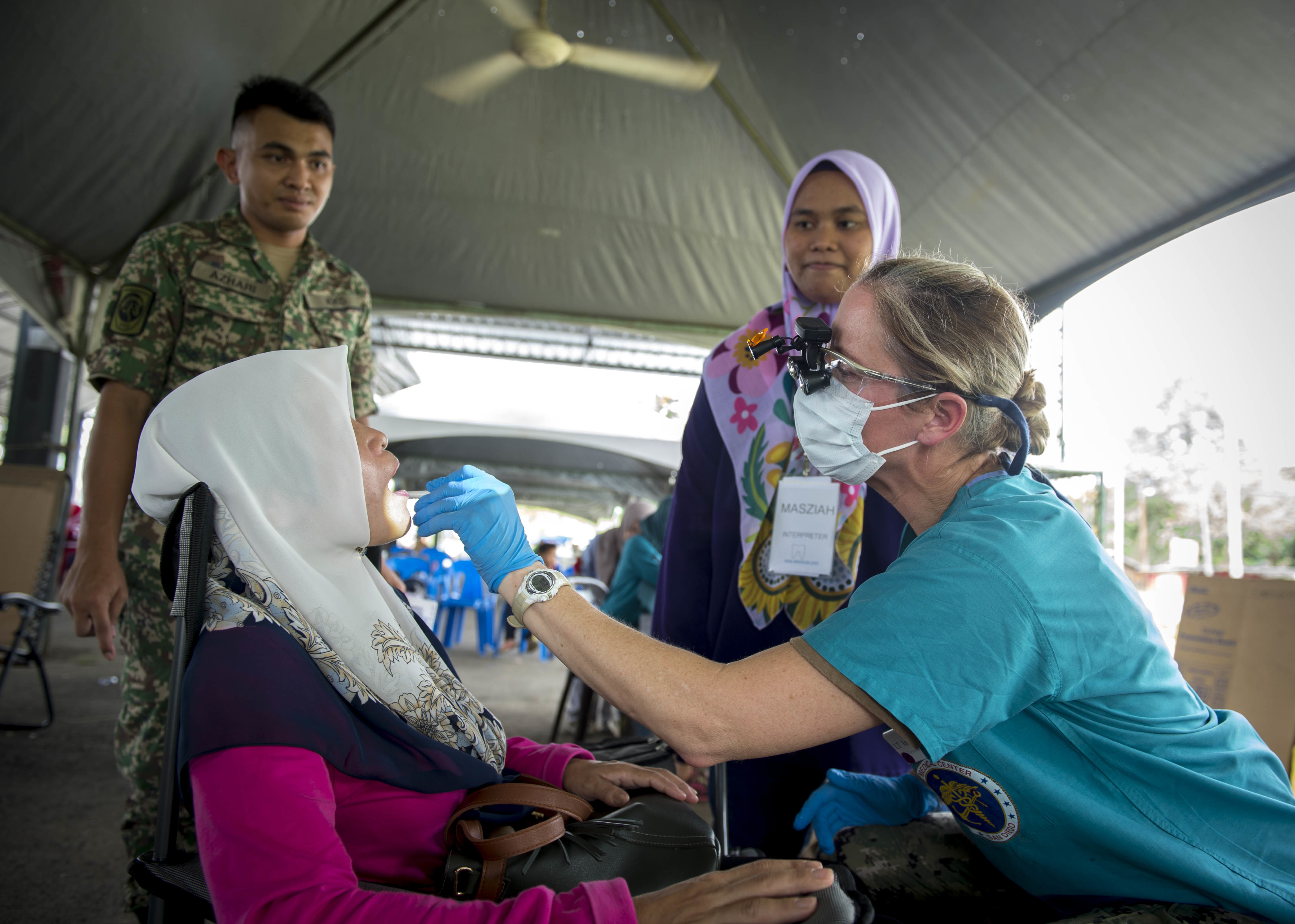 Lt. Inga O'Shea conducts a dental exam in Malaysia during Pacific Partnership 2018.
