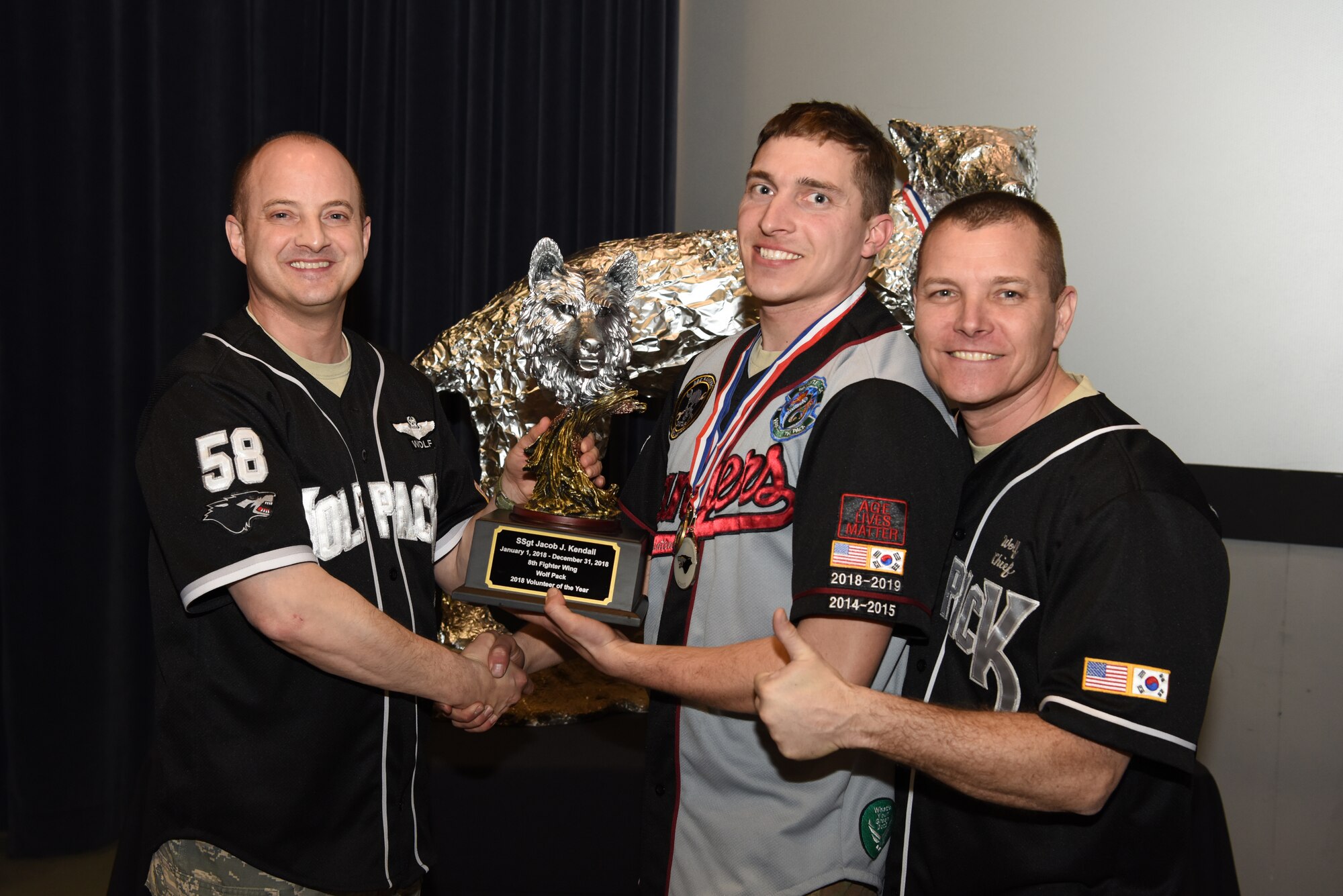 U.S. Air Force Col. John Bosone, 8th Fighter Wing commander, and Chief Master Sgt. Michael Moore Jr., 8th FW command chief, present the Volunteer of the Year to Staff Sgt. Jacob Kendall, 8th Maintenance Squadron, at Kunsan Air Base, Republic of Korea, Feb. 1, 2019. The Kunsan annual award winners will go on to compete at the 7th Air Force level. (U.S. Air Force photo by Staff Sgt. Joshua Edwards)