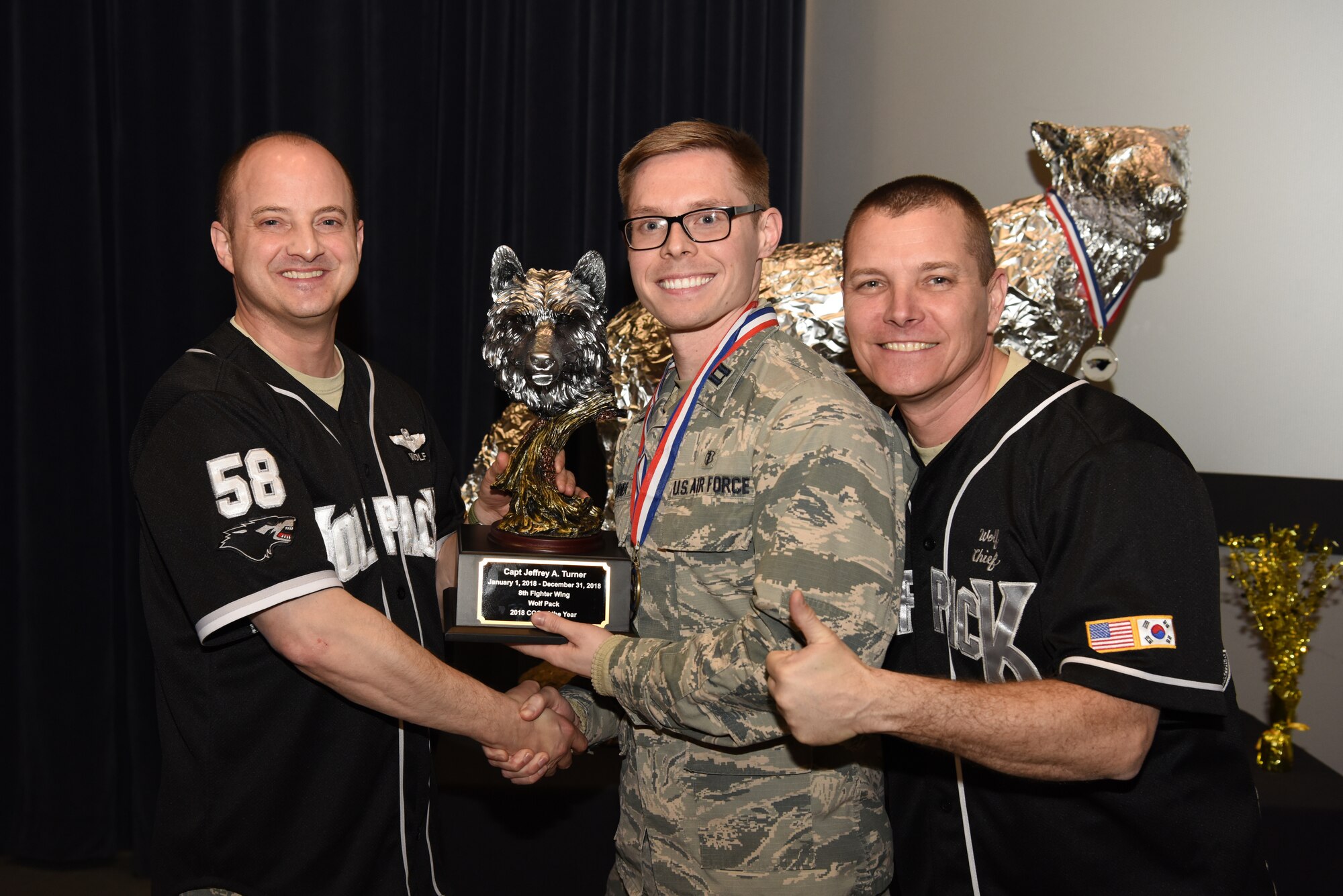 U.S. Air Force Col. John Bosone, 8th Fighter Wing commander, and Chief Master Sgt. Michael Moore Jr., 8th FW command chief, present the Company Grade Officer of the Year to Capt. Jeffery Turner, 8th Medical Operations Squadron, at Kunsan Air Base, Republic of Korea, Feb. 1, 2019. The Kunsan annual award winners will go on to compete at the 7th Air Force level. (U.S. Air Force photo by Staff Sgt. Joshua Edwards)