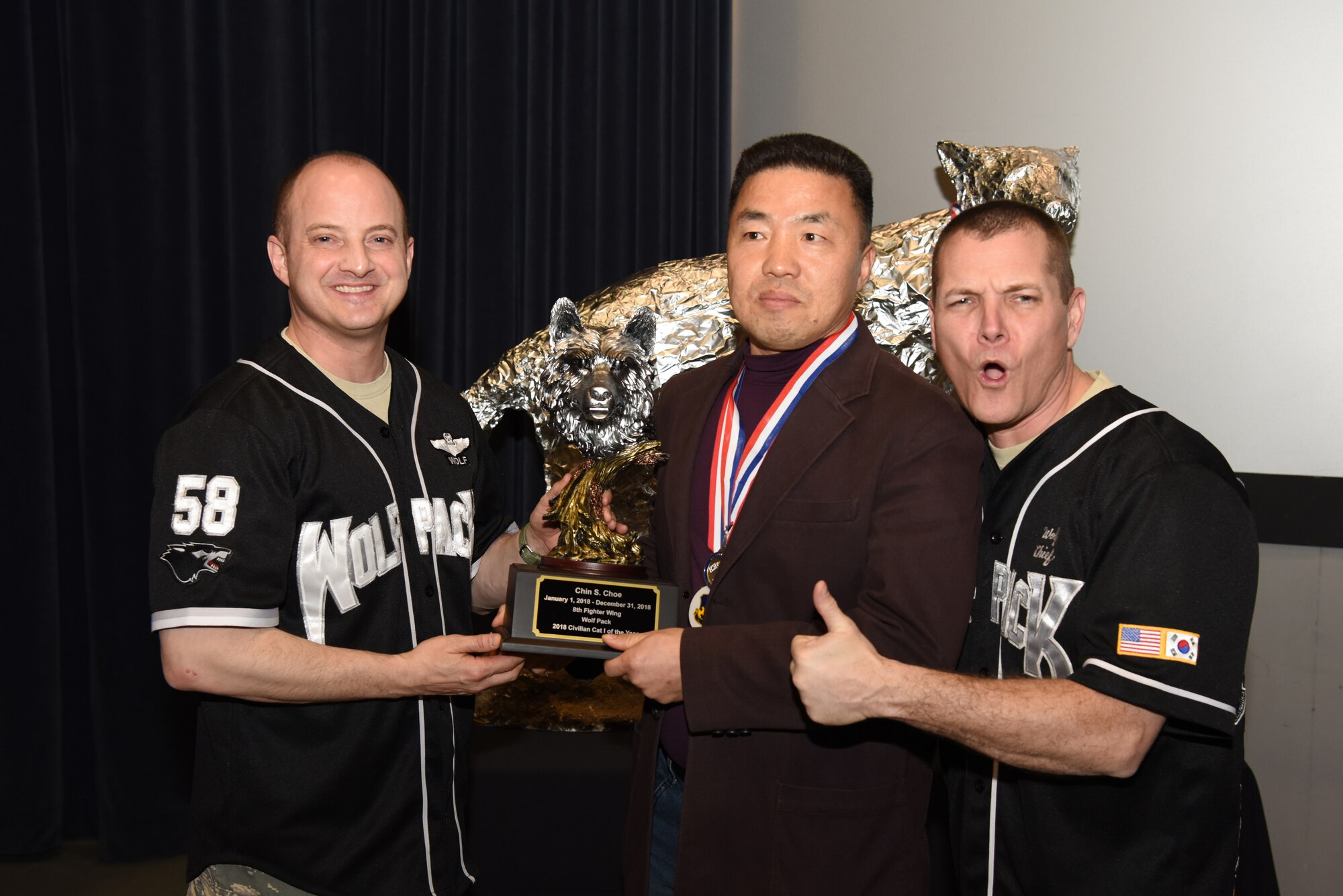 U.S. Air Force Col. John Bosone, 8th Fighter Wing commander, and Chief Master Sgt. Michael Moore Jr., 8th FW command chief, present the Civilian Category I of the Year to Chin Choe, 8th Logistics Readiness Squadron, at Kunsan Air Base, Republic of Korea, Feb. 1, 2019. The Kunsan annual award winners will go on to compete at the 7th Air Force level. (U.S. Air Force photo by Staff Sgt. Joshua Edwards)