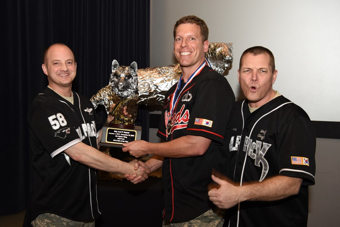 U.S. Air Force Col. John Bosone, 8th Fighter Wing commander, and Chief Master Sgt. Michael Moore Jr., 8th FW command chief, present the Field Grade Officer of the Year to Maj. Joel Haarer, 8th Operations Support Squadron, at Kunsan Air Base, Republic of Korea, Feb. 1, 2019. The Kunsan annual award winners will go on to compete at the 7th Air Force level. (U.S. Air Force photo by Staff Sgt. Joshua Edwards)