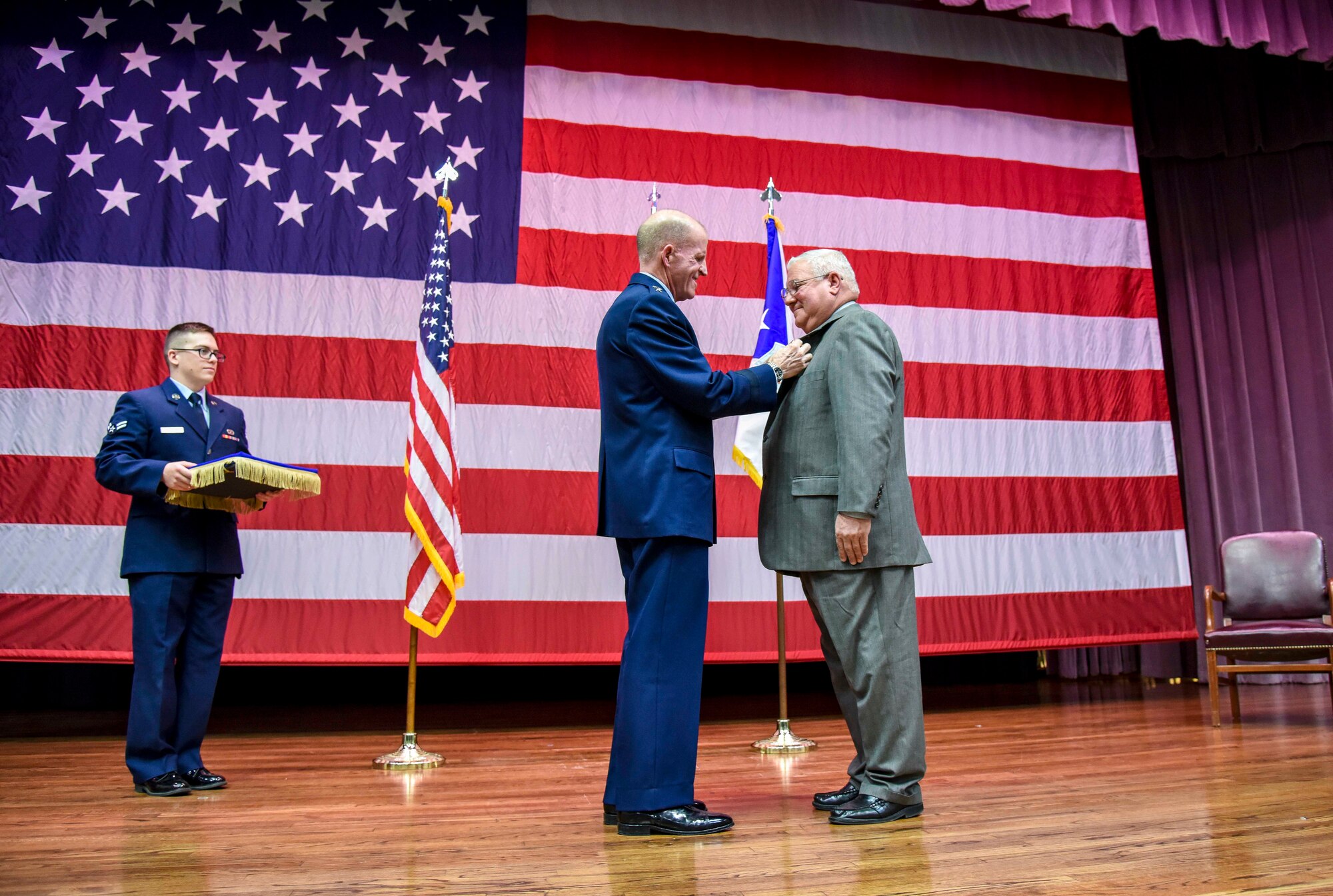 Air Force Vice Chief of Staff Gen. Stephen Wilson pins the Outstanding Civilian Career Service Award onto Richard “Sonic” Johnson, former 14th Flying Training Wing Public Affairs chief, during Johnson’s retirement ceremony at the Kaye Auditorium Jan. 25, 2019, on Columbus Air Force Base, Mississippi. Wilson officiated the retirement ceremony. (U.S. Air Force photo by Melissa Doublin)