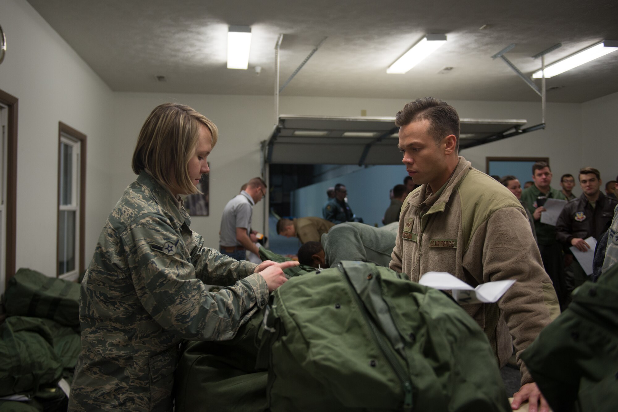 Airman Danuta Lukaszynska, 55th logistics Readiness Squadron, issues mobility bags to members of Team Offutt Jan. 29, 2019, on Offutt Air Force Base, Nebraska. The base participated in Phase I of Operational Readiness Exercise Winter Havoc. (U.S. Air Force photo by Tech. Sgt. Rachelle Blake)