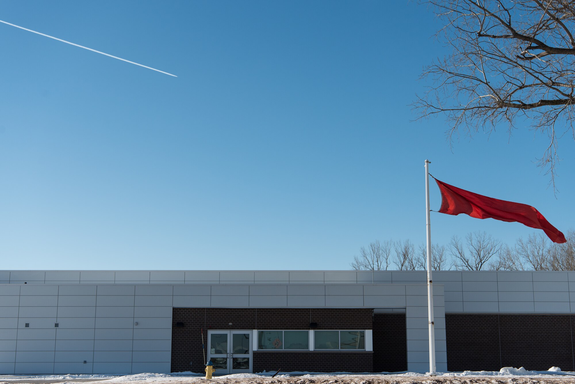 A red flag flies outside the 55th Security Forces Squadron Combat Arm shooting range Feb. 1, 2019, at Offutt Air Force Base, Nebraska. The red flag is raised to signify that the range is active and those in the area should proceed with caution. (U.S. Air Force photo by Senior Airman Jacob Skovo)