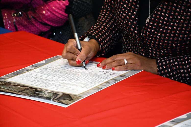 Kari Steele, president of the board of commissioners for the Metropolitan Water Reclamation District of Greater Chicago, signs a ceremonial copy of the project partnership agreement between the Corps and MWRD Jan. 31. The MWRD received $33.8 million in federal funds under authority of Section 1043 of the Water Resources Reform and Development Act of 2014, which allows federal funds to transfer through the U.S. Army Corps of Engineers to local sponsors for authorized projects. (U.S. Army photo by Patrick Bray/Released)