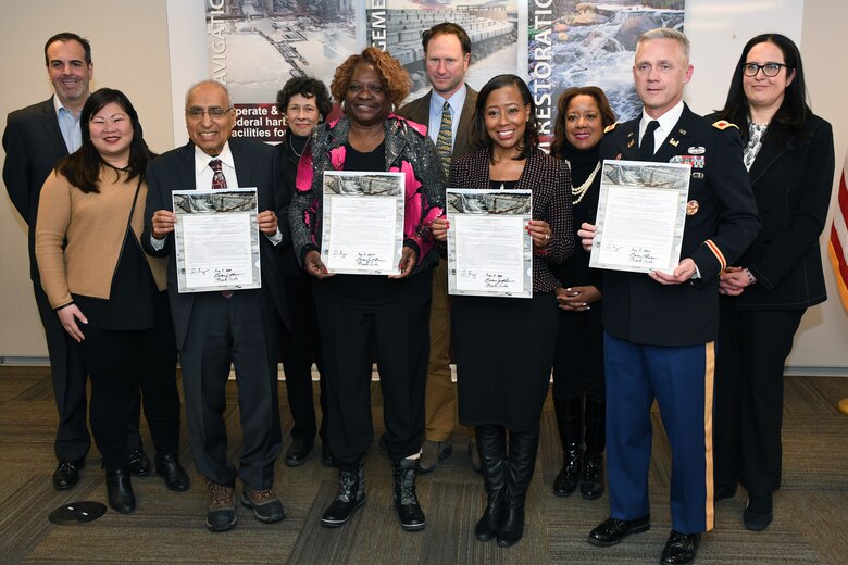 The board of commissioners for the Metropolitan Water Reclamation District of Greater Chicago, stand with Col. Aaron Reisinger (front row, right), commander and district engineer of the U.S. Army Corps of Engineers Chicago District, following a signing ceremony Jan. 3. The MWRD received $33.8 million in federal funds under authority of Section 1043 of the Water Resources Reform and Development Act of 2014, which allows federal funds to transfer through the U.S. Army Corps of Engineers to local sponsors for authorized projects. (U.S. Army photo by Patrick Bray/Released)