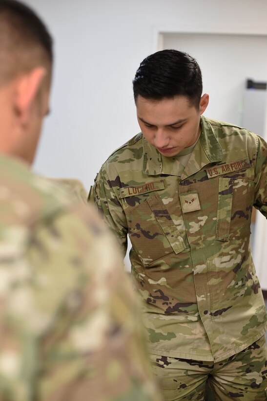Airman 1st Class Joseph Lucero, 14th Operations Support Squadron host aviation resource manager, helps a captain with flight records Jan. 30, 2019, on Columbus Air Force Base, Mississippi. The 14th OSS host aviation resource management (HARM) office will in process students and out process graduated U.S. Air Force pilots. (U.S. Air Force photo by Airman 1st Class Keith Holcomb)