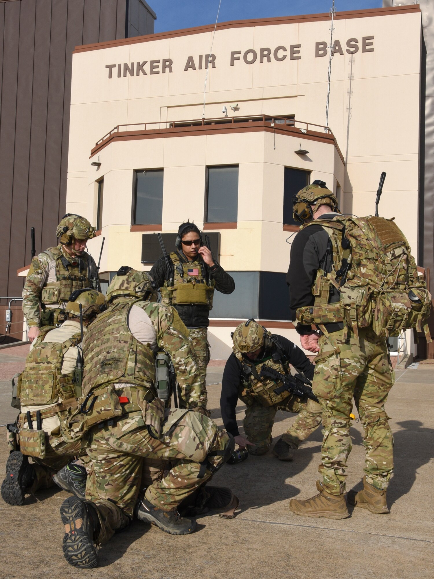 Joint Terminal Attack Controllers of the 137th Special Operations Wing, Oklahoma Air National Guard, review assault plans on the concrete in front of Tinker Air Force Base Operations building during a SENTRY REX 19-01 training mission on Jan. 15.