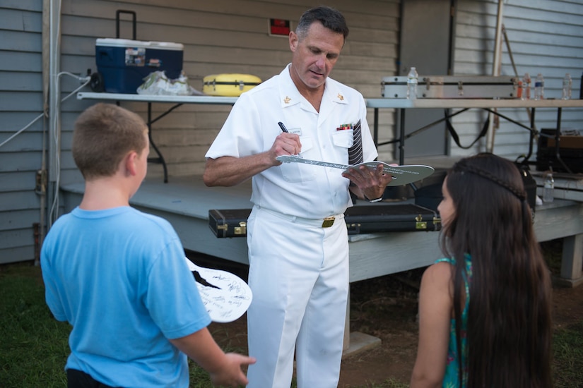 A military musician signs autographs.