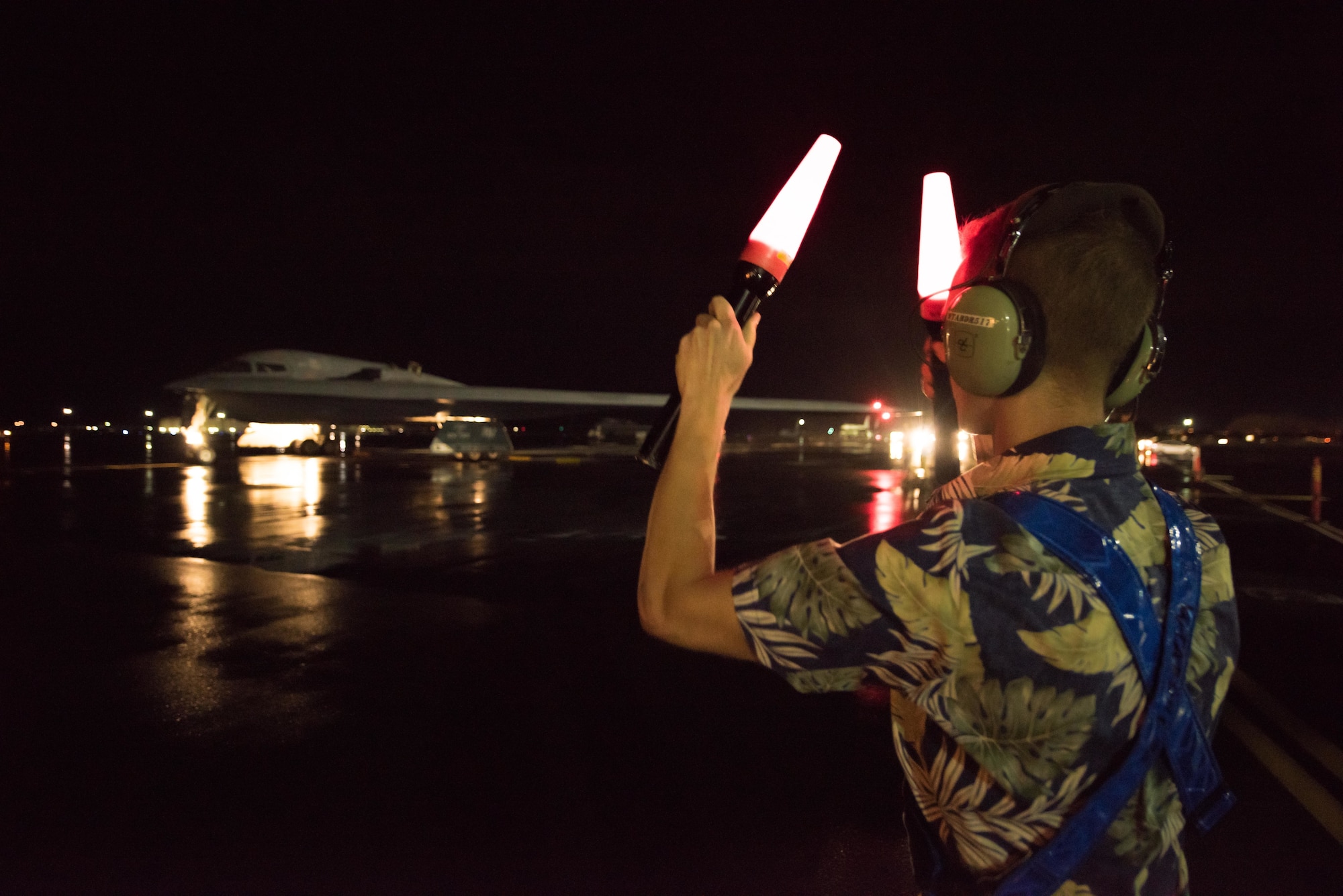 Senior Airman Hayden Thayer, 509th Maintenance Group crew chief deployed from Whiteman Air Force Base, Missouri, marshals a B-2 Spirit at Joint Base Pearl Harbor-Hickam, Hawaii Jan. 31, 2018
