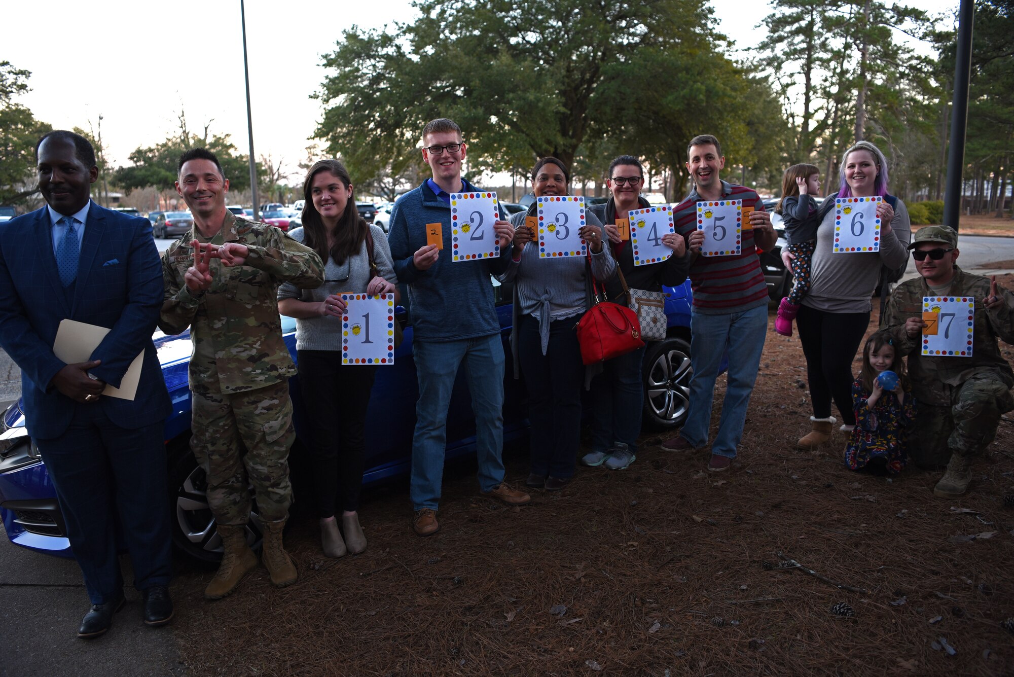 The final seven Team Shaw members in the raffle to win a free car wait in order to try their car key during a Smile Campaign car giveaway wrap-up party at Shaw Air Force Base, S.C., Jan. 31, 2019.