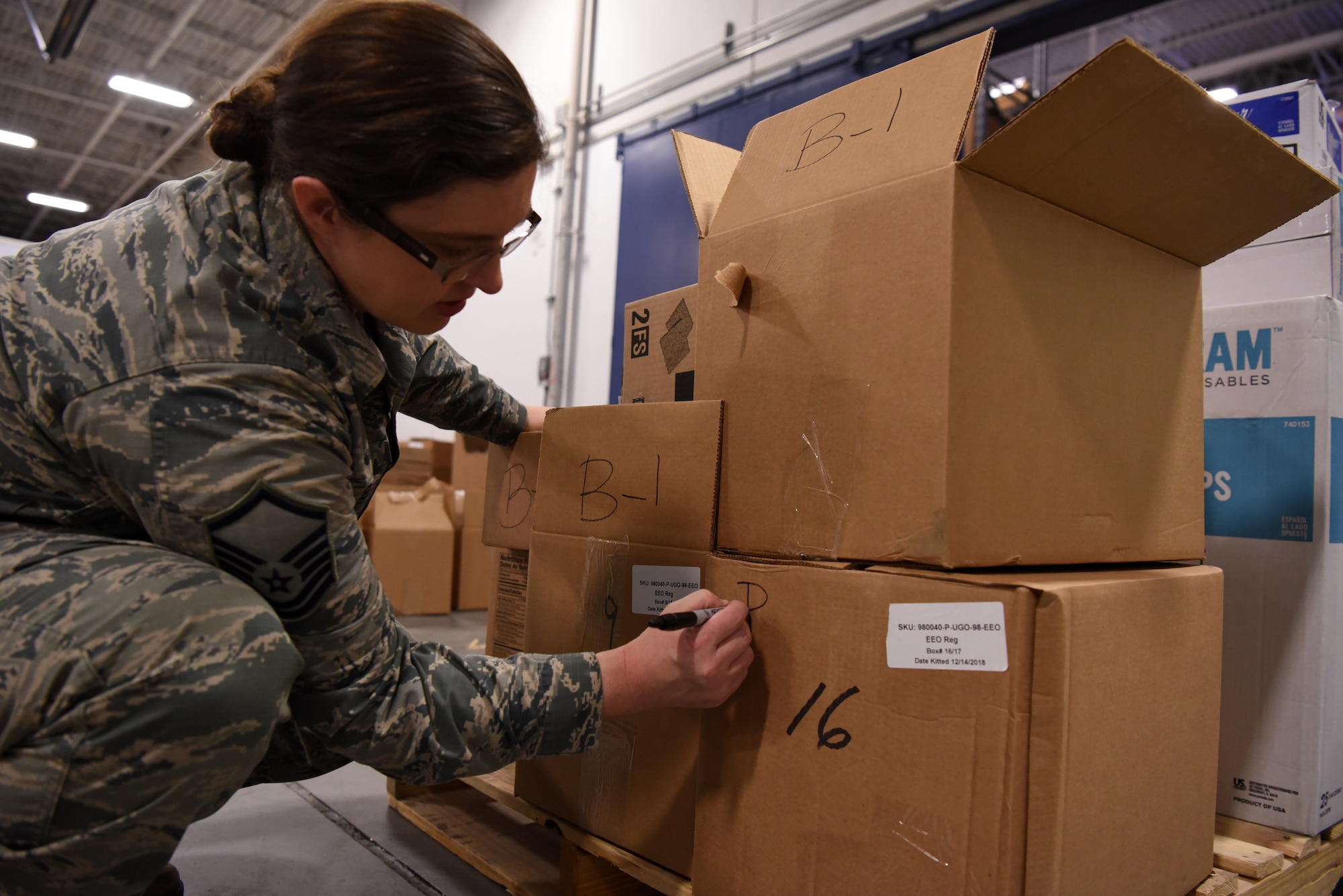 Master Sgt. Tina Bakker, 90th Force Support Squadron Missile Alert Facility Feeding Operations flight chief, writes site locations on packages Jan. 28, 2019, at F. E. Warren Air Force Base, Wyo. The care packages are part of the USO2GO initiative, where snacks are transported to missile alert facility sites to boost morale for Airmen in the field. (U.S. Air Force photo by Tech. Sgt. Ashley Manz)