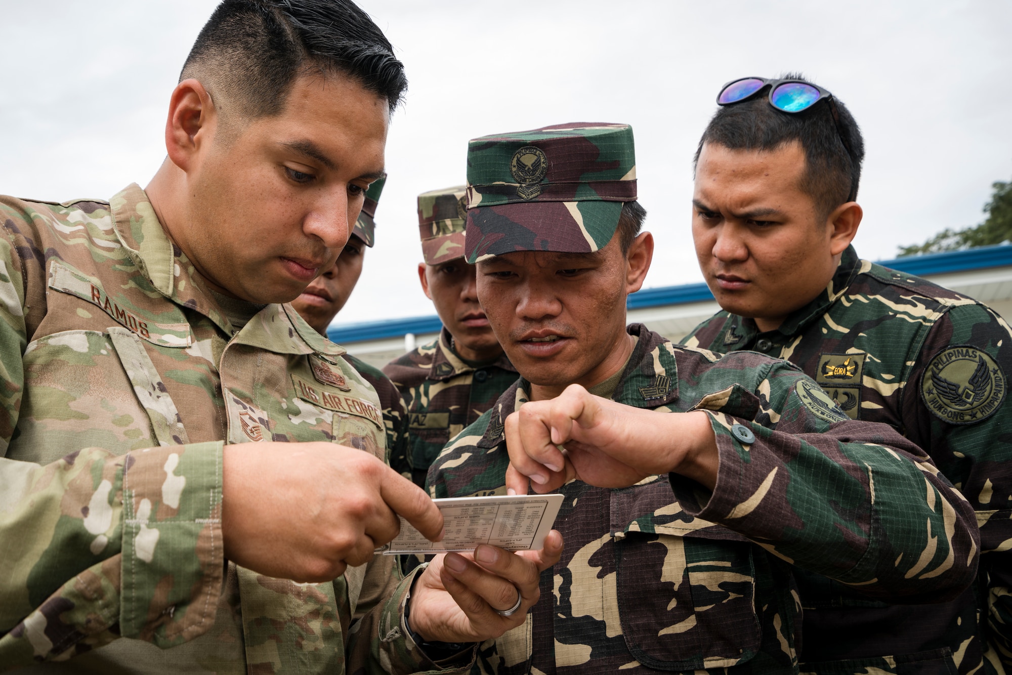 U.S. Air Force Master Sgt. Roger Ramos, Pacific Air Forces (PACAF) Directorate of Air and Cyberspace Operations communication planner, demonstrates how to use a slide rule tool to communication personnel from the Philippine Air Force 950th Communications, Electronics and Information Systems Group during a subject matter expert exchange that is part of the Bilateral Air Contingent Exchange-Philippines (BACE-P) at Cesar Basa Air Base, Philippines, January 30, 2019.