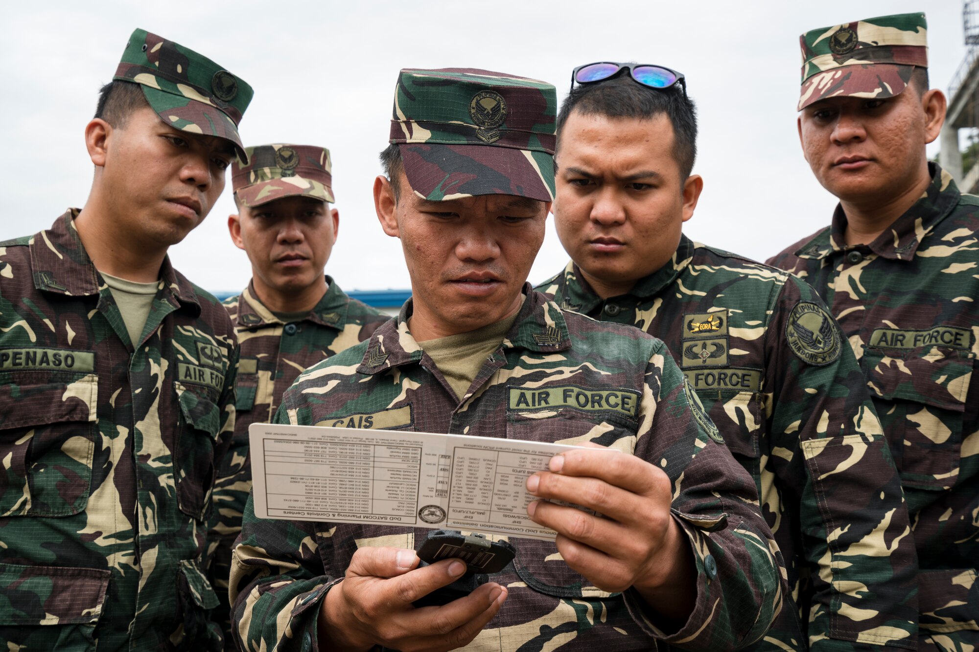 Philippine Air Force 950th Communications, Electronics and Information Systems Group communication personnel practice using a pocket transit and slide rule to align satellite during Bilateral Air Contingent Exchange-Philippines (BACE-P) at Cesar Basa Air Base, Philippines, January 30, 2019.