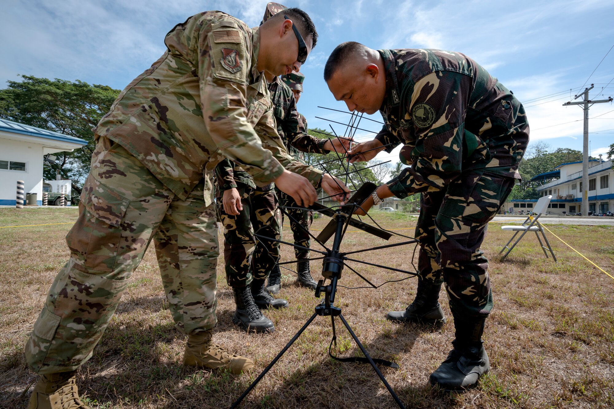 U.S. Air Force Master Sgt. Roger Ramos, a communication planner with Pacific Air Forces (PACAF) Directorate of Air and Cyberspace Operations, works with Philippine Air Force Capt. Genimar Javier, commander, 547th Communications Electronic Informations Systems Squadron, to set up a tactical satellite antenna during Bilateral Air Contingent Exchange-Philippines (BACE-P) at Cesar Basa Air Base, Philippines, January 30, 2019.