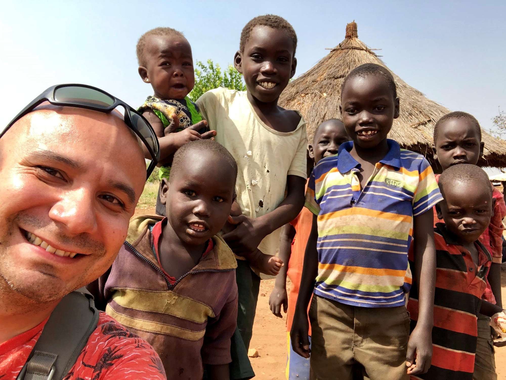 Chaplain (Capt.) Benjamin Quintanilla, assigned to the 28th Bomb Wing, visits with children on a trip to Adjumani, Uganda, in January 2019. Quintanilla visited Adjumani to work alongside Tutapona, an organization that provides trauma rehabilitation to refugees. (Courtesy photo by Candice Lassey)