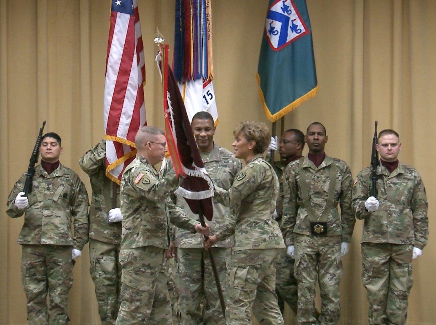 Lt. Gen. Nadja Y. West, The Surgeon General of the U.S. Army and commander, Army Medical Command (right), passes the colors to Lt. Gen. Michael D. Lundy, Commander, Combined Arms Center and Fort Leavenworth, Kansas, while Maj. Gen. Patrick D. Sargent, commanding general, the AMEDDC&S HRCoE (center), looks on.