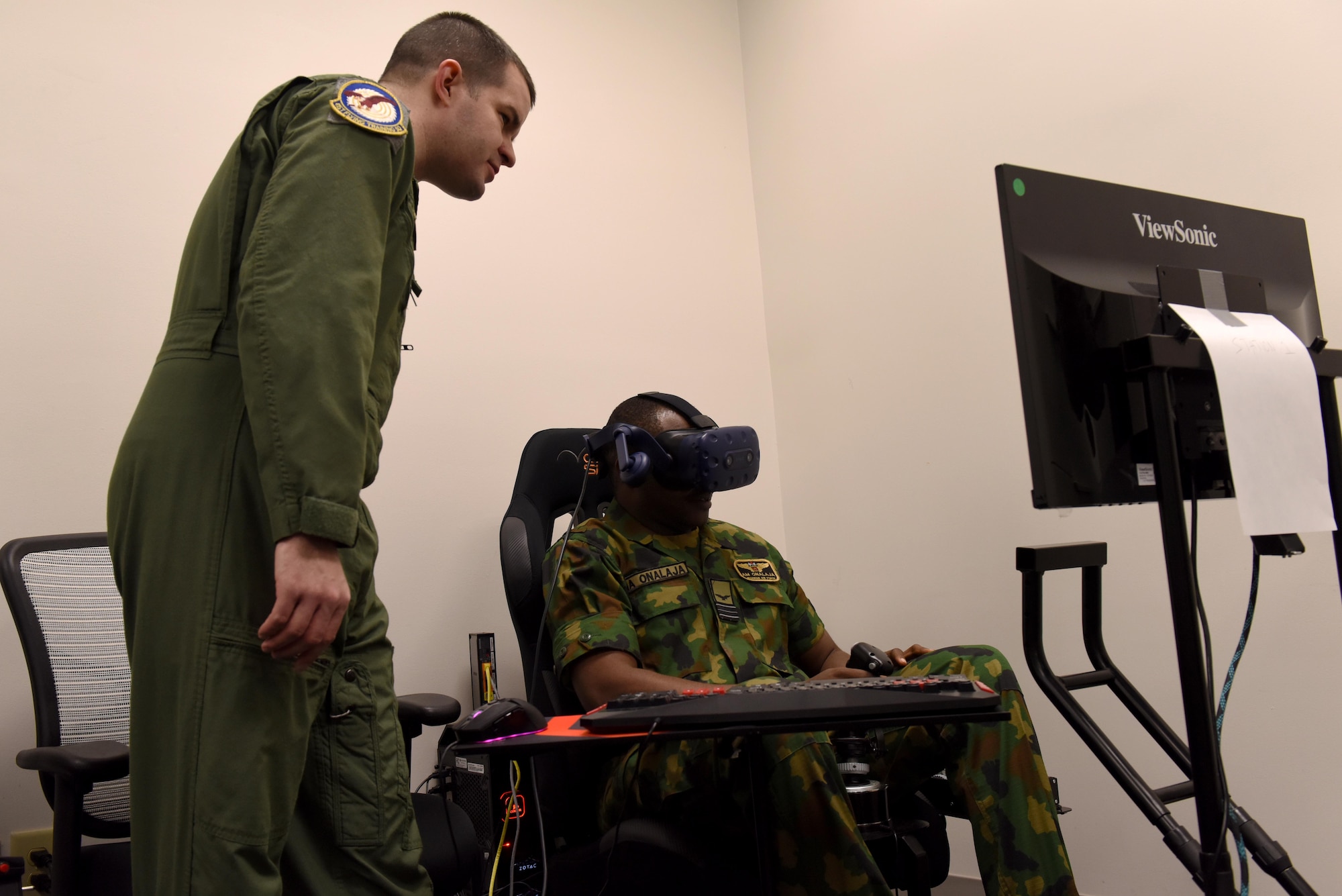 Maj. James Stillwagon, 37th Flying Training Squadron instructor pilot, shows Squadron Leader Adedamola Onalaja, Nigerian Air Force, how their virtual reality training works Jan. 23, 2019, on Columbus Air Force Base, Mississippi. The Nigerian Air Force members visited Columbus AFB to check on one of their students and to see the different aspects of pilot training. (U.S. Air Force photo by Senior Airman Beaux Hebert)