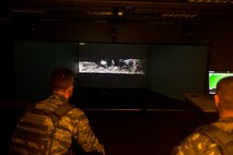 U.S. Air Force Col. Benjamin Bishop, the 354th Fighter Wing commander, participates in a scenario on the MILO Range system with a 354th Security Forces Squadron Airman Jan. 29, 2018, at Eielson Air Force Base, Alaska. Bishop experienced first-hand how the simulator helps prepare Airmen for scenarios they can possibly run into. (U.S. Air Force photo by Senior Airman Isaac Johnson)