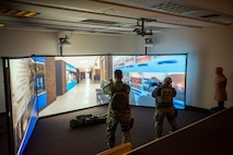 U.S. Air Force Col. Benjamin Bishop, the 354th Fighter Wing commander, participates in a scenario on the MILO Range system with a 354th Security Forces Squadron Airman Jan. 29, 2018, at Eielson Air Force Base, Alaska. Bishop experienced first-hand how the simulator helps prepare Airmen for scenarios they can possibly run into. (U.S. Air Force photo by Senior Airman Isaac Johnson)