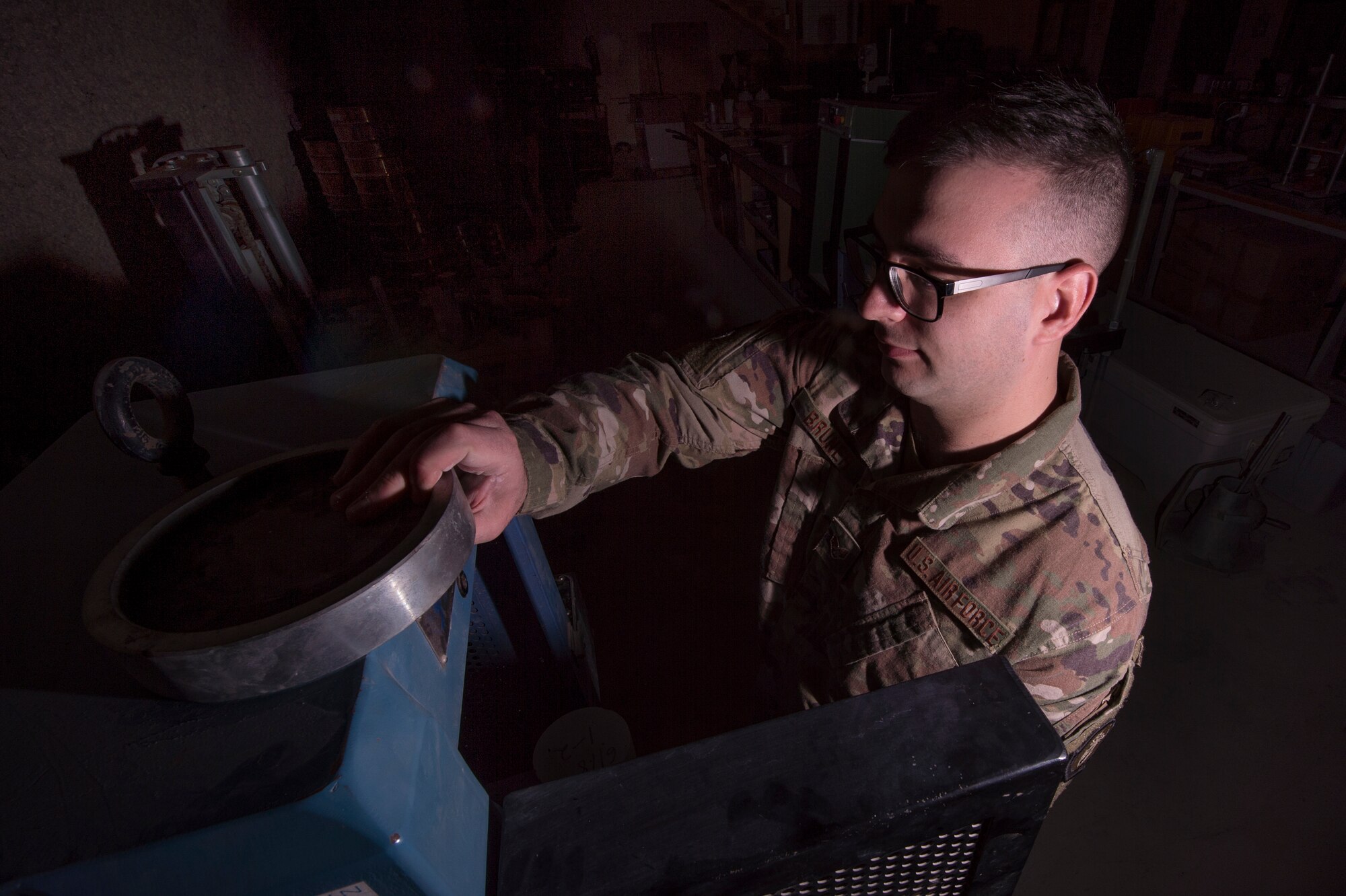 Senior Airman Dylan Bruner, 577th Expeditionary Prime Base Engineer Emergency Force Squadron (PRIME BEEF) engineering assistant, measures a concrete sample’s “load” capacity using a concrete compression testing machine Feb. 1, 2019, at Al Udeid Air Base, Qatar. PRIME BEEF Airmen provide support to forward deployed civil engineers who are engaged in the construction of various assets such as quality of life facilities, concrete roads, and airfield aprons in the U.S. Air Forces Central Command’s area of responsibility. (U.S. Air Force photo by Tech. Sgt. Christopher Hubenthal)