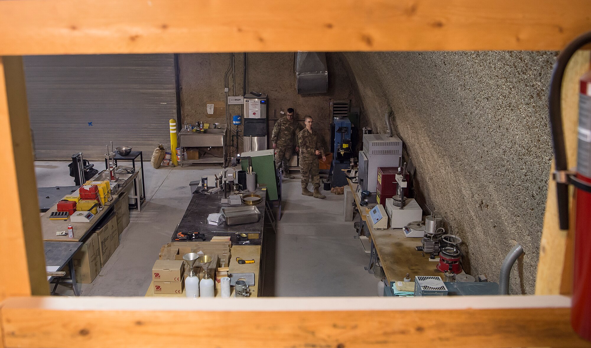 Senior Airman Dylan Bruner, left, 577th Expeditionary Prime Base Engineer Emergency Force Squadron (PRIME BEEF) engineering assistant, and Tech. Sgt. Kevin Elkins, 577th PRIME BEEF design cell drafting NCO in charge,  use a concrete compression testing machine to test the “load” capacity of concrete Feb. 1, 2019, at Al Udeid Air Base, Qatar.  PRIME BEEF Airmen provide support to forward deployed civil engineers who are engaged in the construction of various assets such as quality of life facilities, concrete roads, and airfield aprons in the U.S. Air Forces Central Command’s area of responsibility. (U.S. Air Force photo by Tech. Sgt. Christopher Hubenthal)