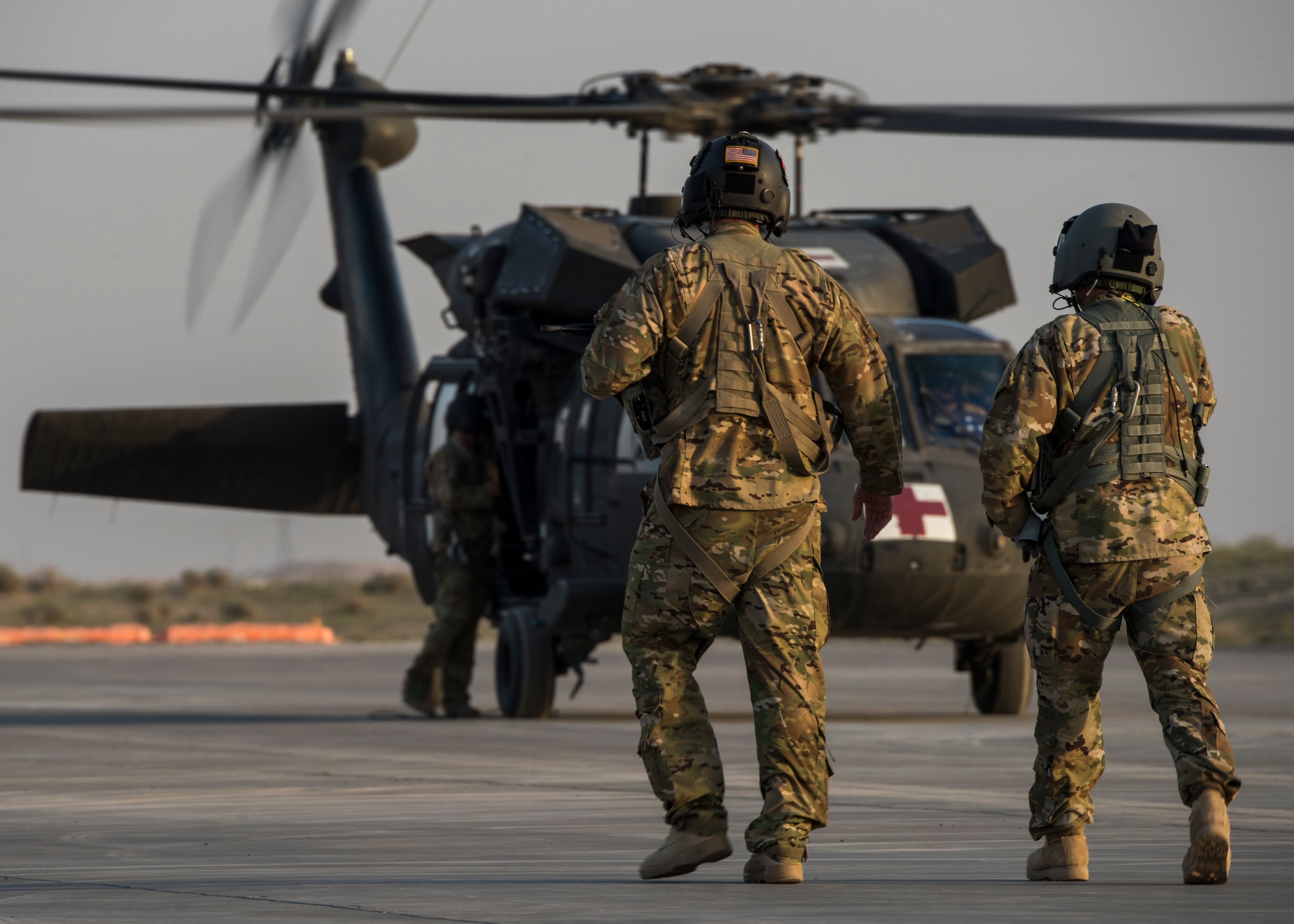 U.S. Army aircrew walk to a UH-60 Blackhawk Jan. 31, 2018, at an undisclosed location in Southwest Asia. The 386th Expeditionary Medical Group facilitate transfers of ill personnel from across the area of responsibility back to the United States or other locations to receive required care.