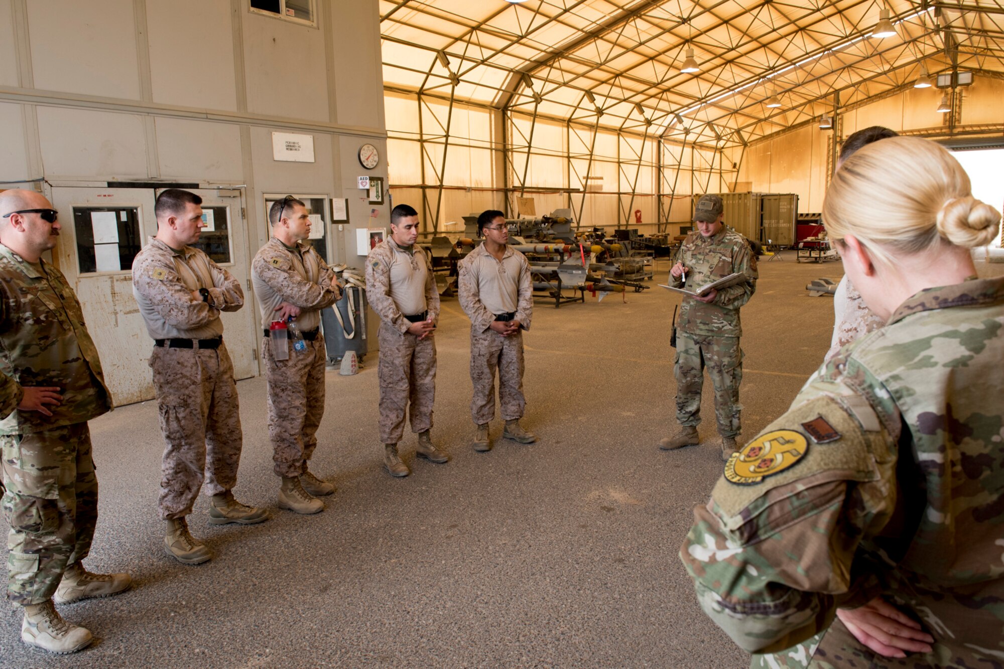 U.S Air Force Munitions crew invite Marines to build bombs in support of OIR