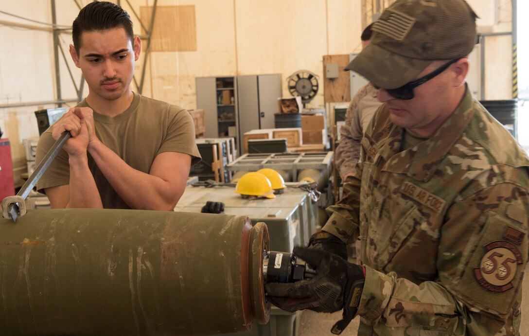 U.S Air Force Munitions crew invite Marines to build bombs in support of OIR