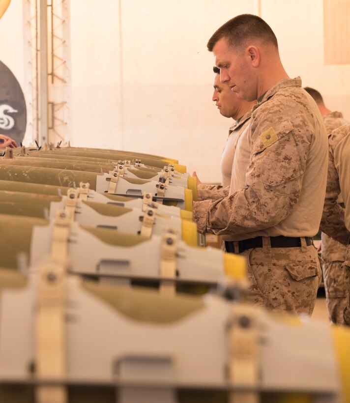 U.S Air Force Munitions crew invite Marines to build bombs in support of OIR