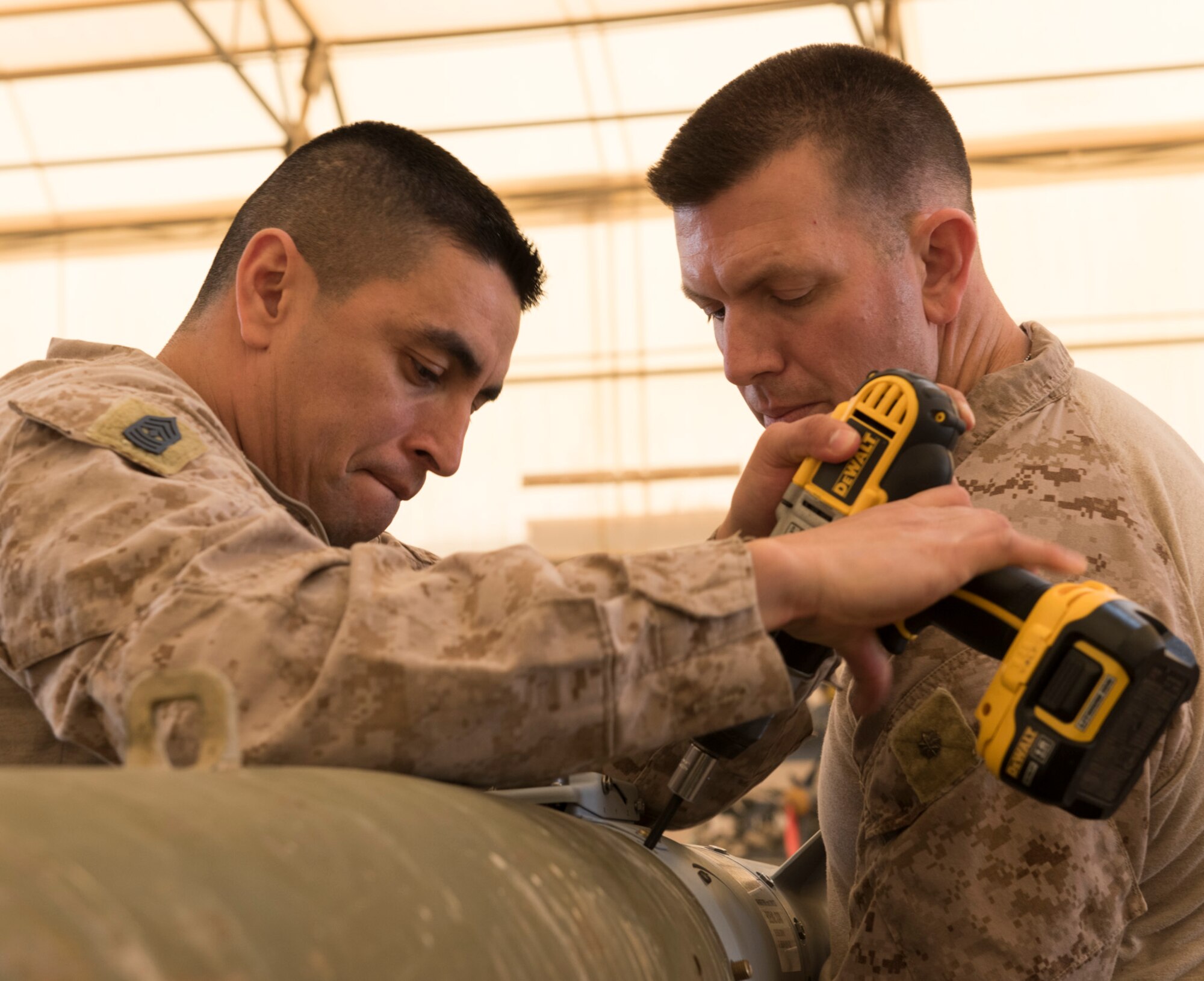 U.S Air Force Munitions crew invite Marines to build bombs in support of OIR