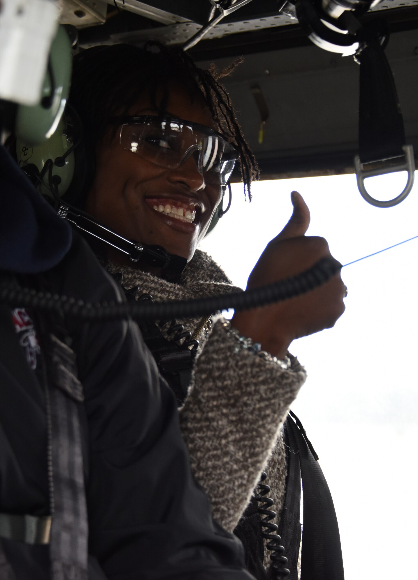 Andrija Dandridge, a watch commander with U.S. Customs and Border Protection, gives a thumbs up sign inside an HH-60G Pave Hawk helicopter before takeoff at Francis S. Gabreski Air National Guard Base, N.Y., Oct. 13, 2018.