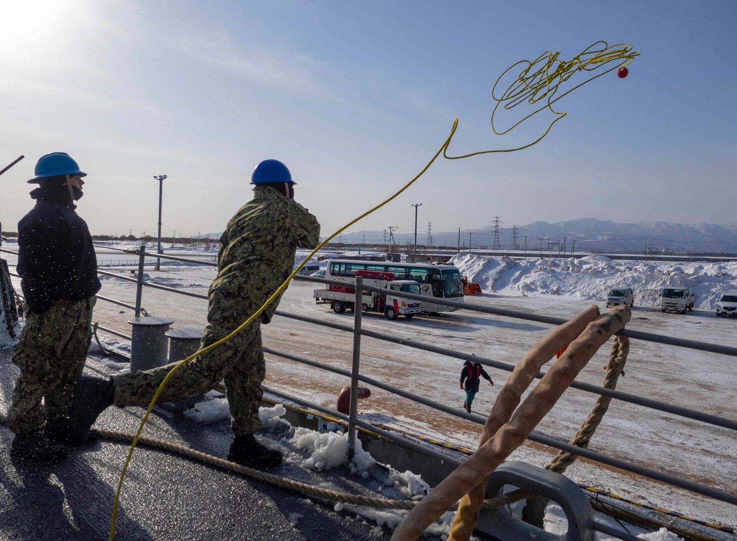 190203-N-CP113-001 ISHIKARI, Japan (Feb. 03, 2019) U.S. Navy Sailor throws line to the pier aboard the Ticonderoga-class guided-missile cruiser USS Antietam (CG 54) while pulling into Ishikari to attend the 70th Annual Sapporo Snow Festival. This is the 36th year the U.S. Navy has participated in the festival, allowing Sailors a unique opportunity to experience Japanese culture and tradition while strengthening the close friendship between the U.S. Navy and the citizens of Japan. (U.S. Navy photo by Lt. Marissa Liu/Released)