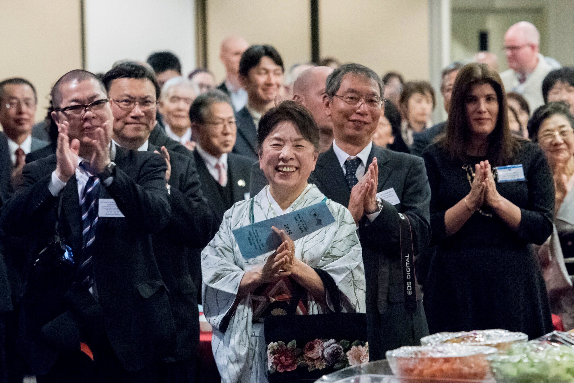 Audience members applause after a new years greeting given by Col. Otis C. Jones, 374th Airlift Wing commander, during the U.S.-Japan Joint New Year’s Party at Yokota Air Base, Japan, Jan. 26, 2019.