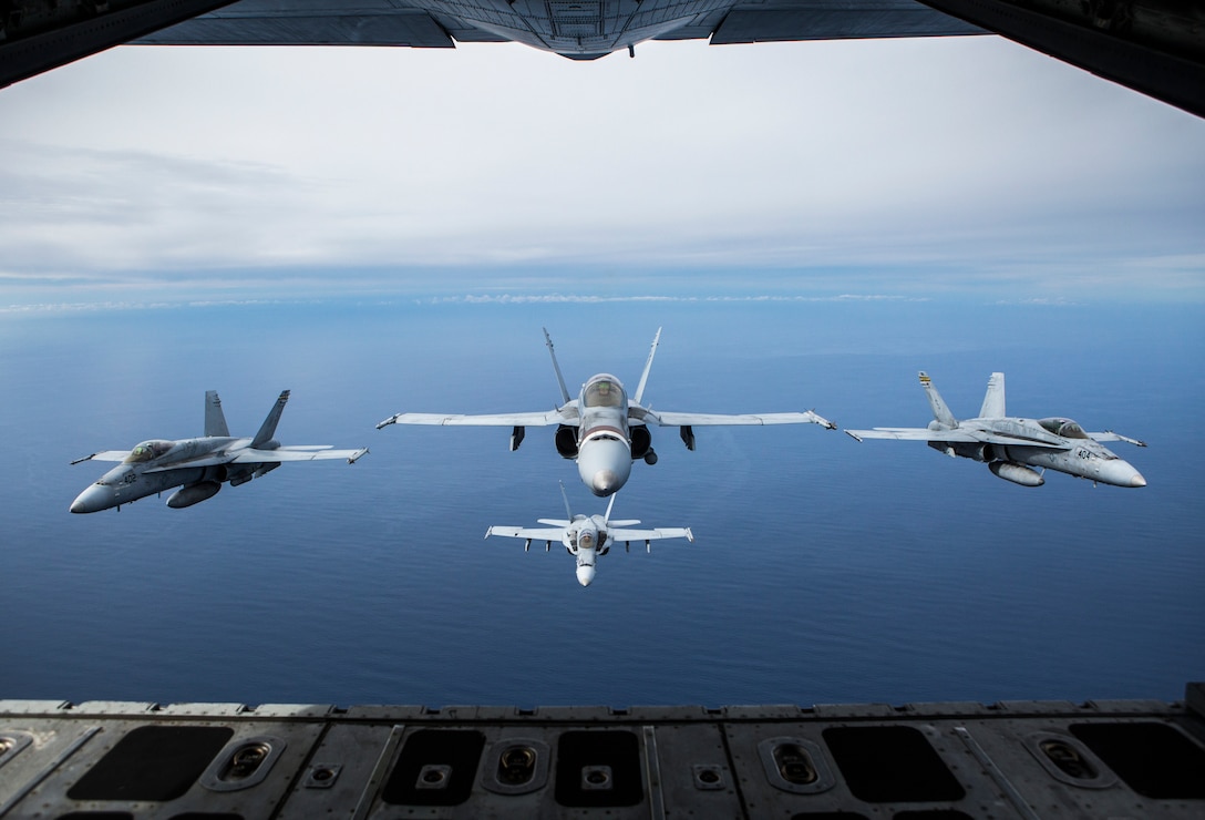 Four F/A-18C Hornets assigned to Marine Fighter Attack Squadron 323 fly in formation behind a KC-130J Super Hercules attached to Marine Aerial Refueler Transport Squadron 352, Marine Aircraft Group 11, during a readiness exercise called the ‘Elephant Walk’ above Marine Corps Air Station Miramar, Calif., Feb. 1, 2019.  MAG-11 conducted this training to exercise its real-world capabilities. Exercises such as this provide realistic, relevant training necessary for 3rd MAW to “Fix, Fly, and Fight” as the Marine Corps’ largest aircraft wing and ensures the unit remains combat-ready, inter-operable, deployable on short notice, and lethal when called into action.