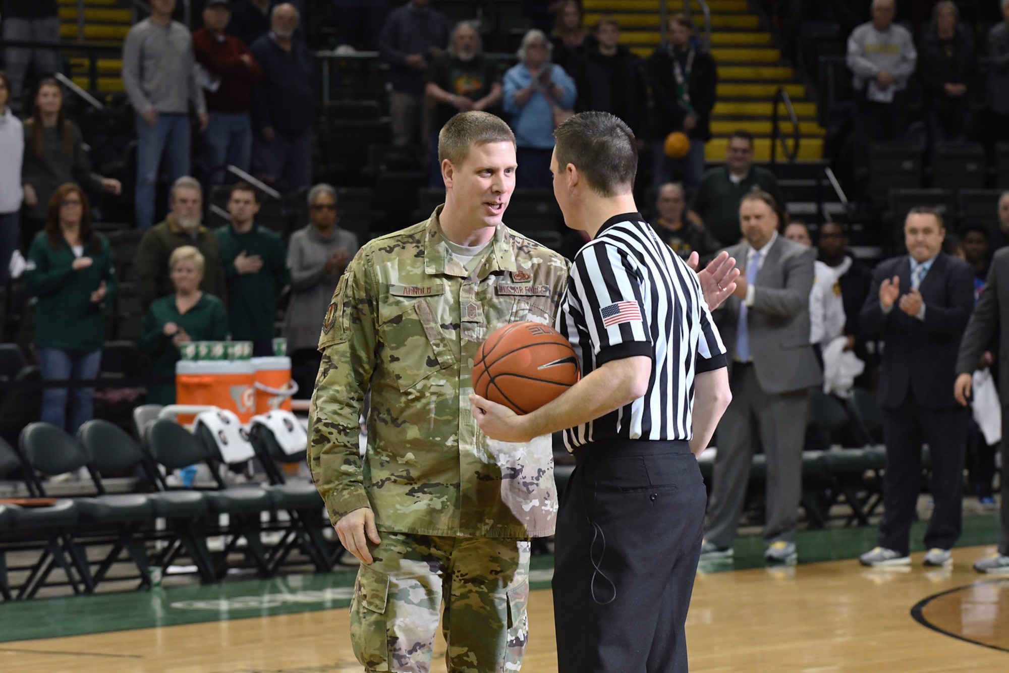 Chief Master Sgt. Kennon Arnold, Air Force Research Laboratory command chief, delivers the official game ball to the official at half court prior to the Wright State University men’s basketball game on Jan. 26, 2018. (Courtesy photo).